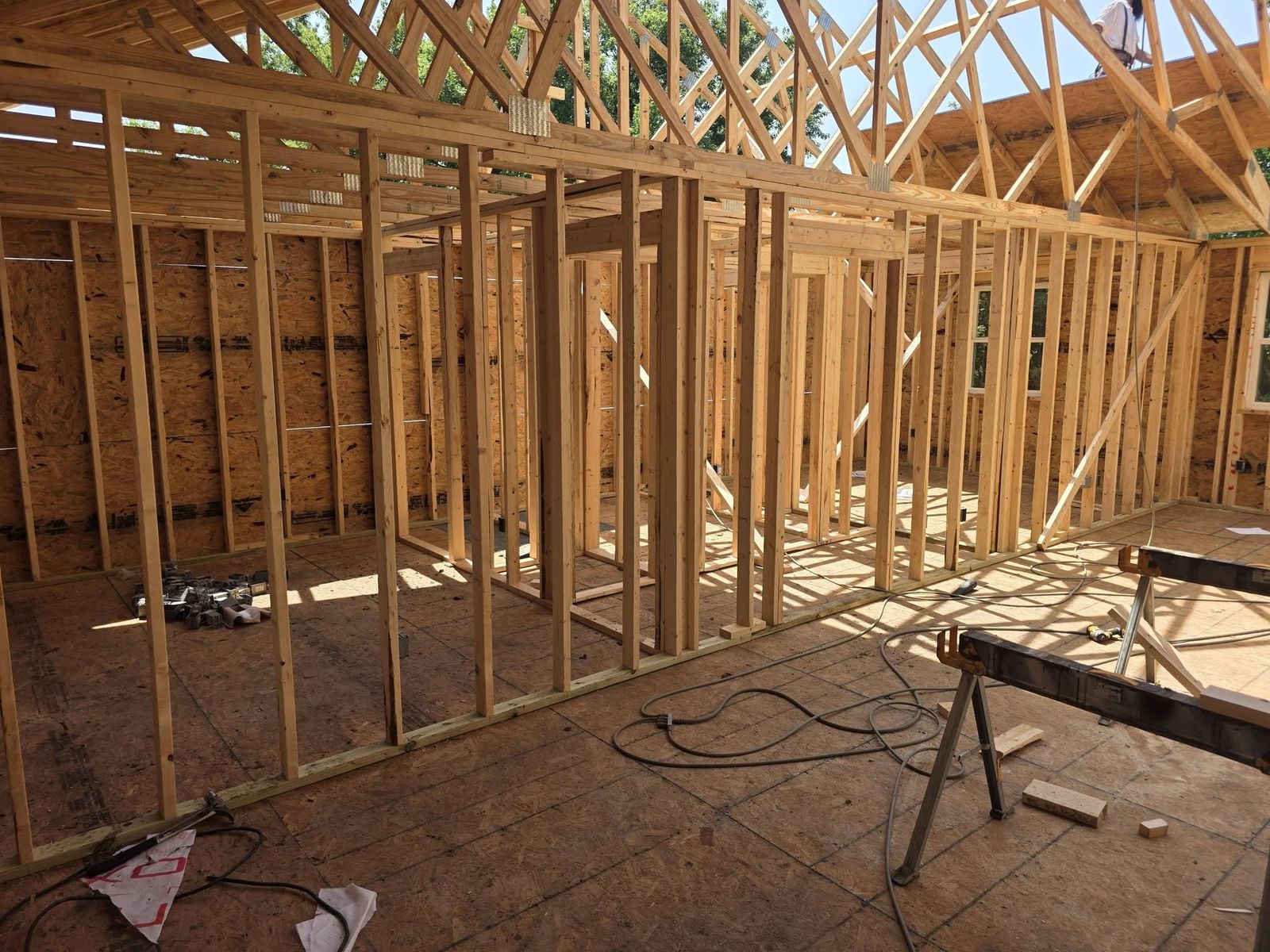 Interior stud walls and roof trusses inside a house under construction