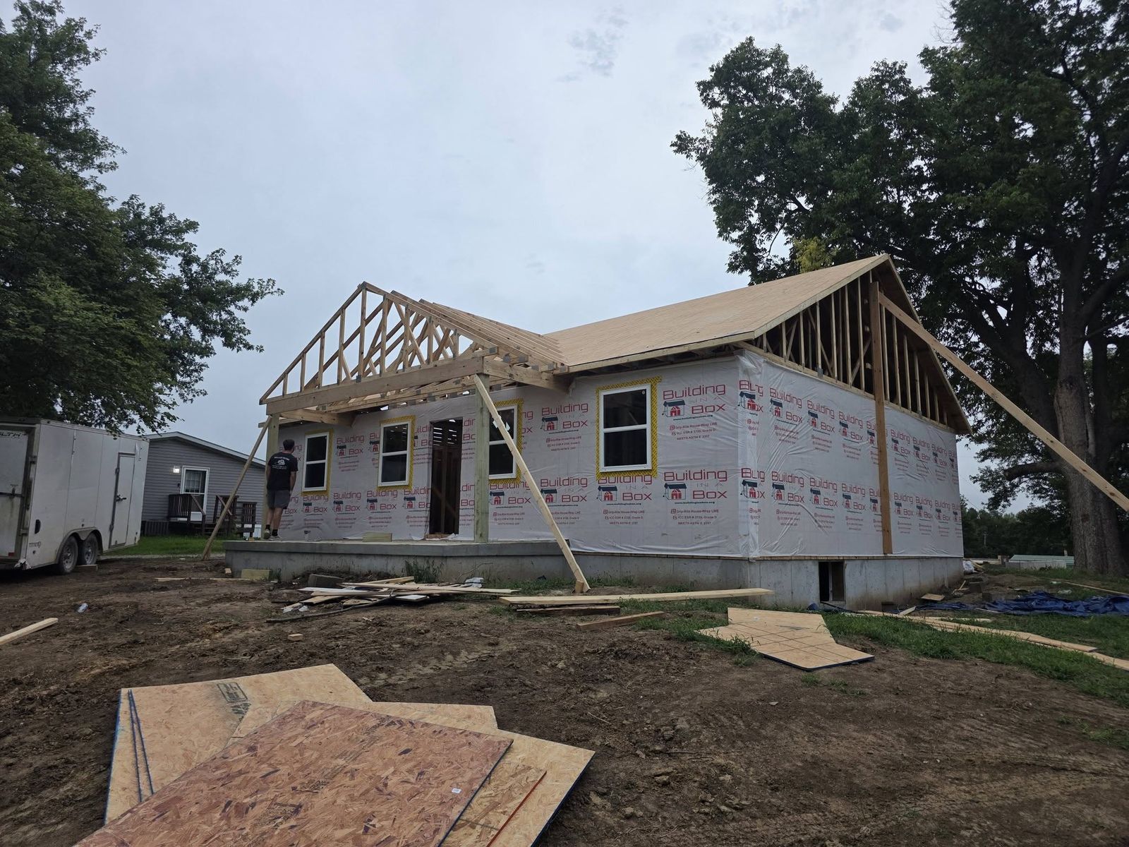 Roof trusses set and house wrap on the walls during framing of a new home